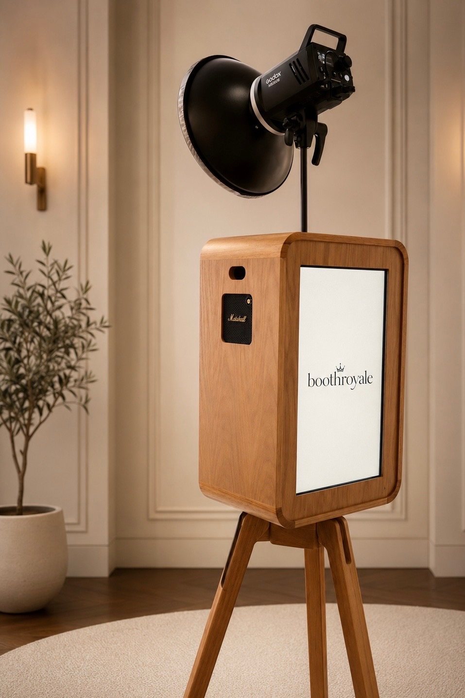 Close detail of the oak booth face: touchscreen, Marshall speaker grille and studio strobe.